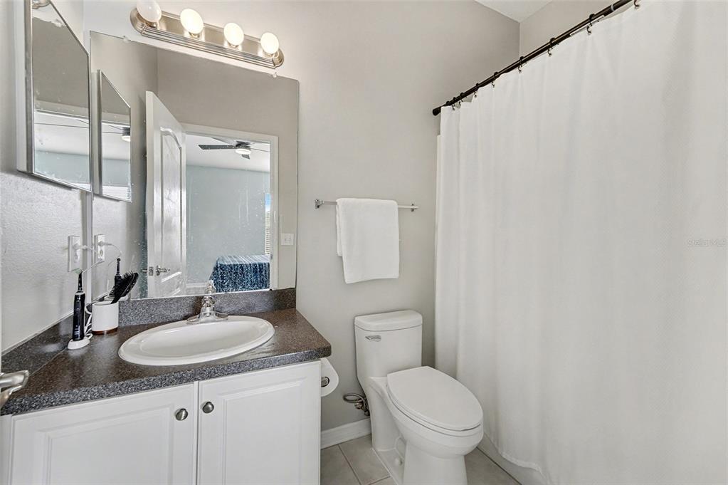 5860 Fishhawk Ridge Drive Lithia, FL 33547 - Photo 14 of 31 a bathroom with a granite countertop sink toilet and a mirror