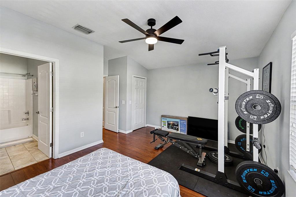 5860 Fishhawk Ridge Drive Lithia, FL 33547 - Photo 18 of 31 a bedroom with bed and a clock on the dresser