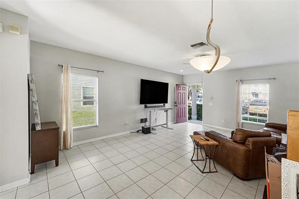5860 Fishhawk Ridge Drive Lithia, FL 33547 - Photo 22 of 31 a living room with furniture and a flat screen tv