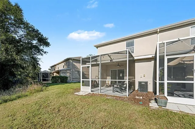 a view of a house with backyard and porch