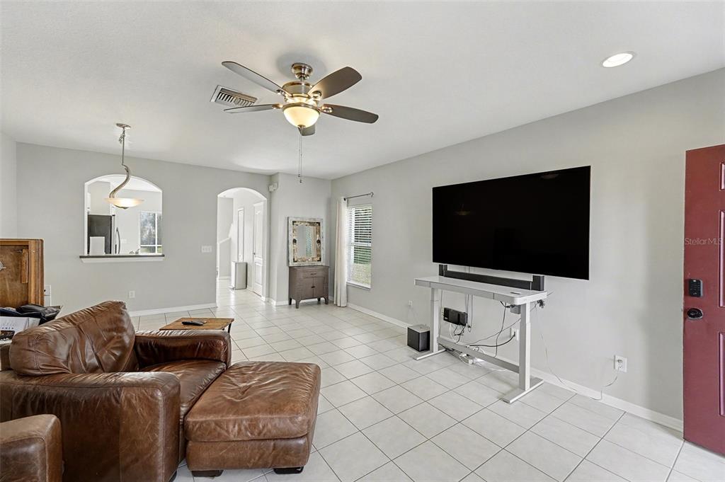 5860 Fishhawk Ridge Drive Lithia, FL 33547 - Photo 5 of 31 a living room with furniture and a flat screen tv