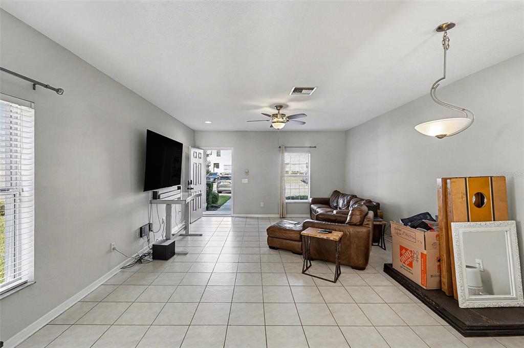 5860 Fishhawk Ridge Drive Lithia, FL 33547 - Photo 6 of 31 a living room with furniture and a flat screen tv
