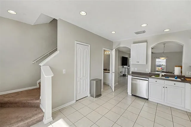 a large kitchen with a sink and cabinets