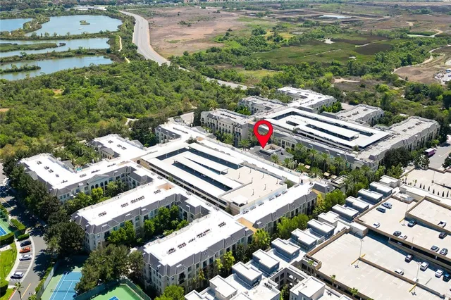an aerial view of multiple houses with yard