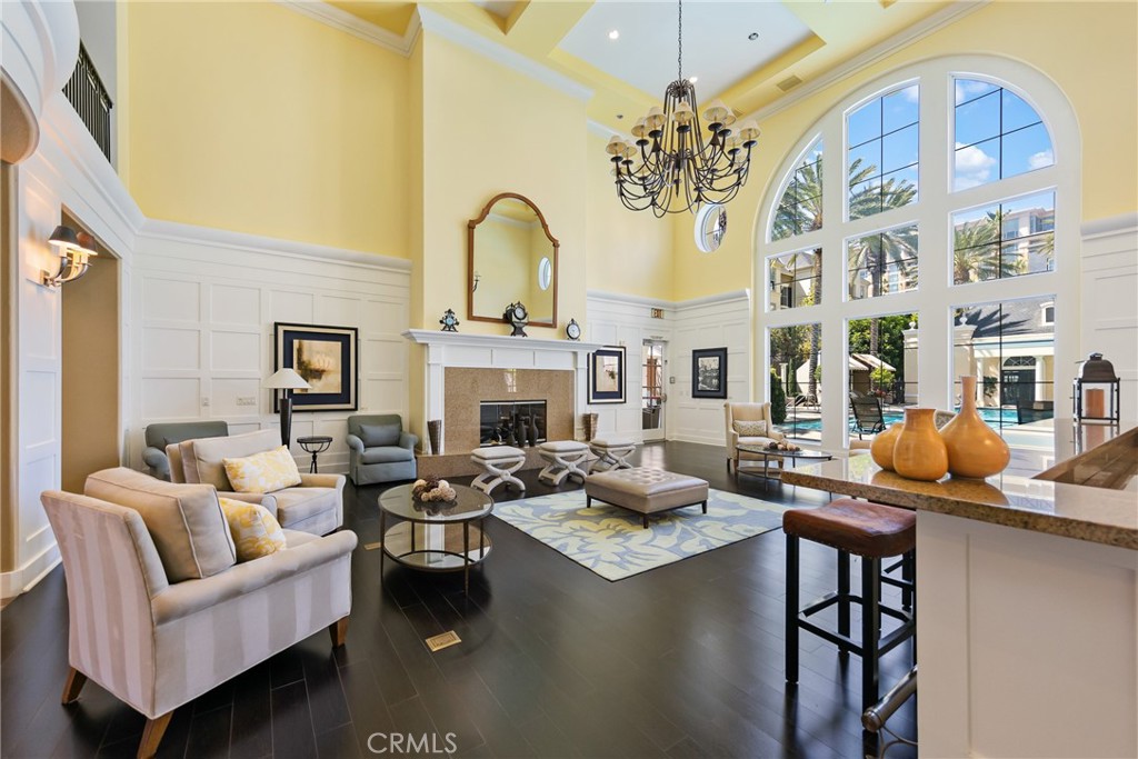 3311 Watermarke Place Irvine, CA 92612 - Photo 22 of 33 a living room with fireplace furniture and a chandelier