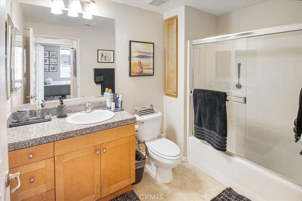 3311 Watermarke Place Irvine, CA 92612 - Photo 7 of 33 a bathroom with a granite countertop sink toilet and shower