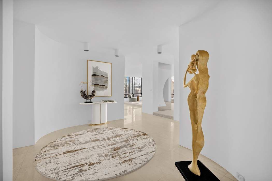 870 United Nations Plaza, Unit 28A Manhattan, NY 10017 - Photo 10 of 28 a bedroom with a bed and a chandelier