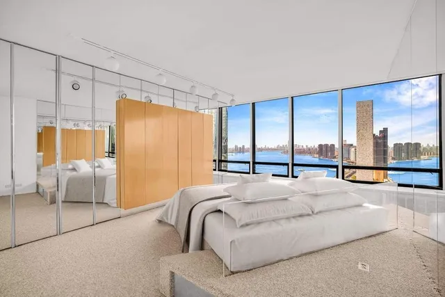 a large bedroom with a large bed and a large window