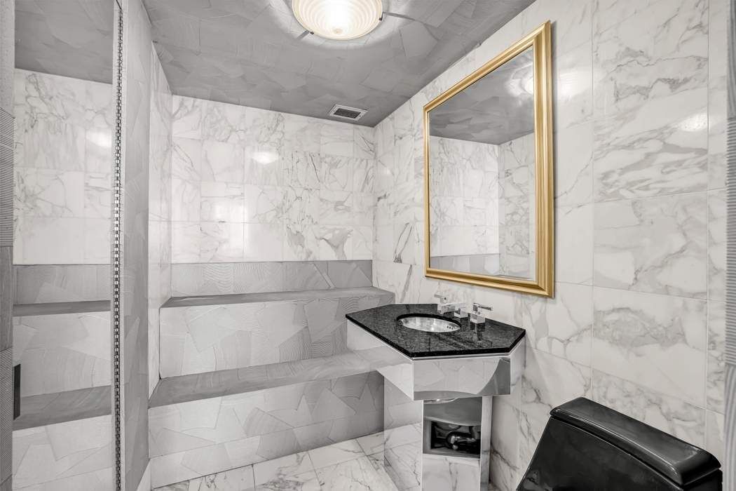 870 United Nations Plaza, Unit 28A Manhattan, NY 10017 - Photo 16 of 28 a bathroom with a sink and a mirror