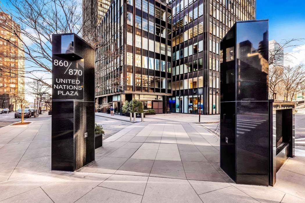 870 United Nations Plaza, Unit 28A Manhattan, NY 10017 - Photo 19 of 28 a city street lined with tall buildings
