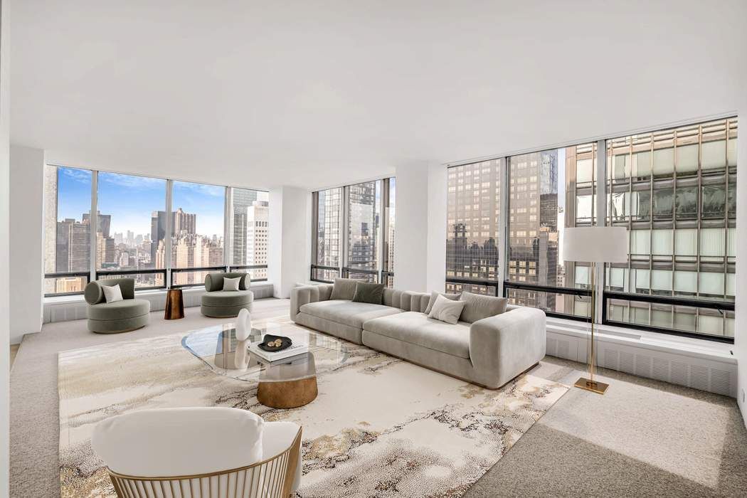 870 United Nations Plaza, Unit 28A Manhattan, NY 10017 - Photo 2 of 28 a living room with furniture and a floor to ceiling window