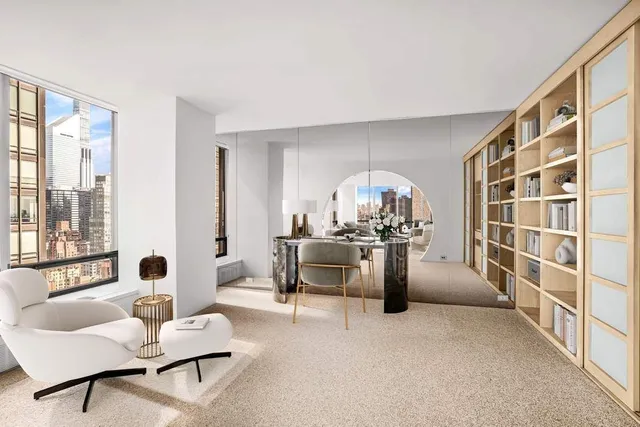 a living room with furniture a rug and a large window