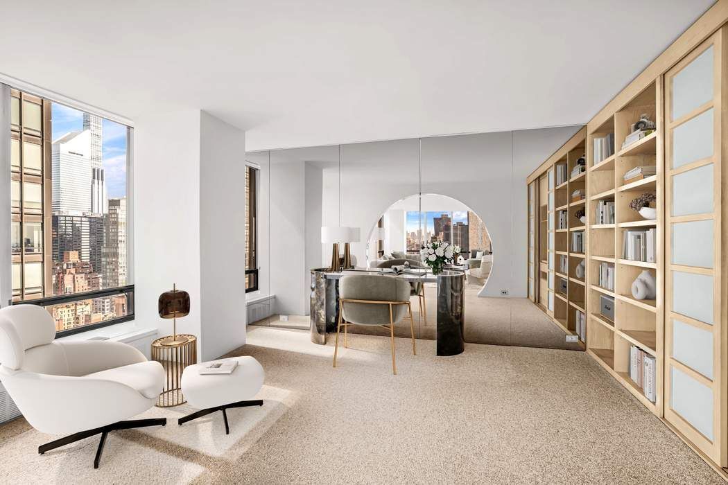 870 United Nations Plaza, Unit 28A Manhattan, NY 10017 - Photo 5 of 28 a living room with furniture and a large window