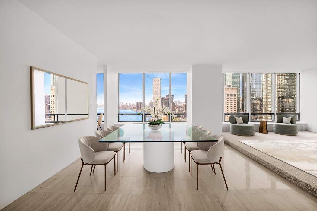 870 United Nations Plaza, Unit 28A Manhattan, NY 10017 - Photo 6 of 28 a living room with furniture a dining table and a large window