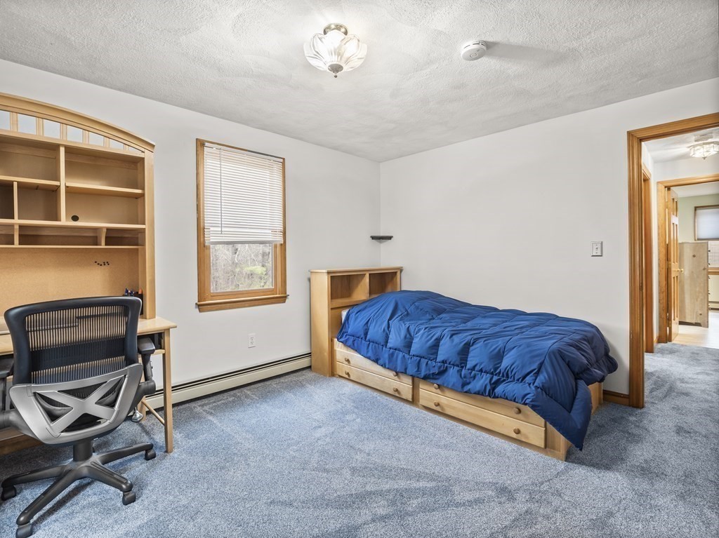17 Chestnut Road Tyngsboro, MA 01879 - Photo 22 of 41 a bedroom with a bed and a chair