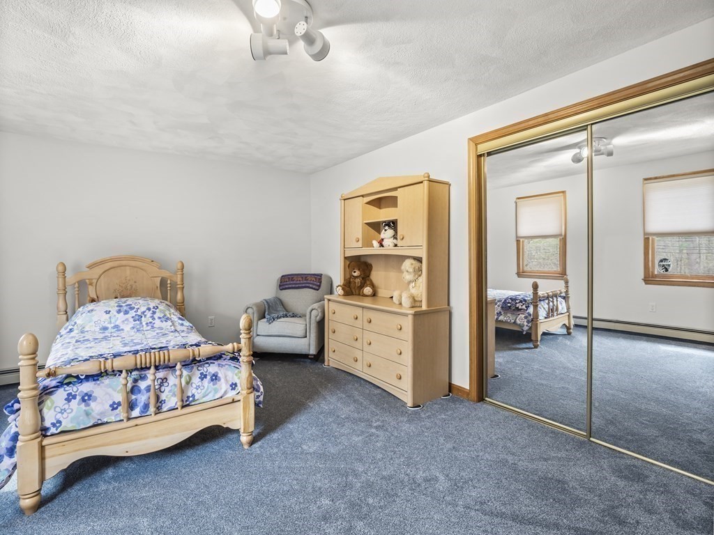 17 Chestnut Road Tyngsboro, MA 01879 - Photo 26 of 41 a bedroom with a bed and a chandelier