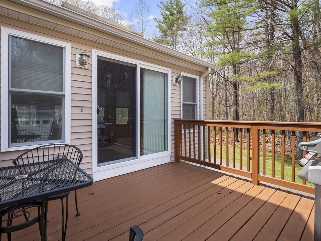 17 Chestnut Road Tyngsboro, MA 01879 - Photo 28 of 41 a view of a wooden deck with a bench