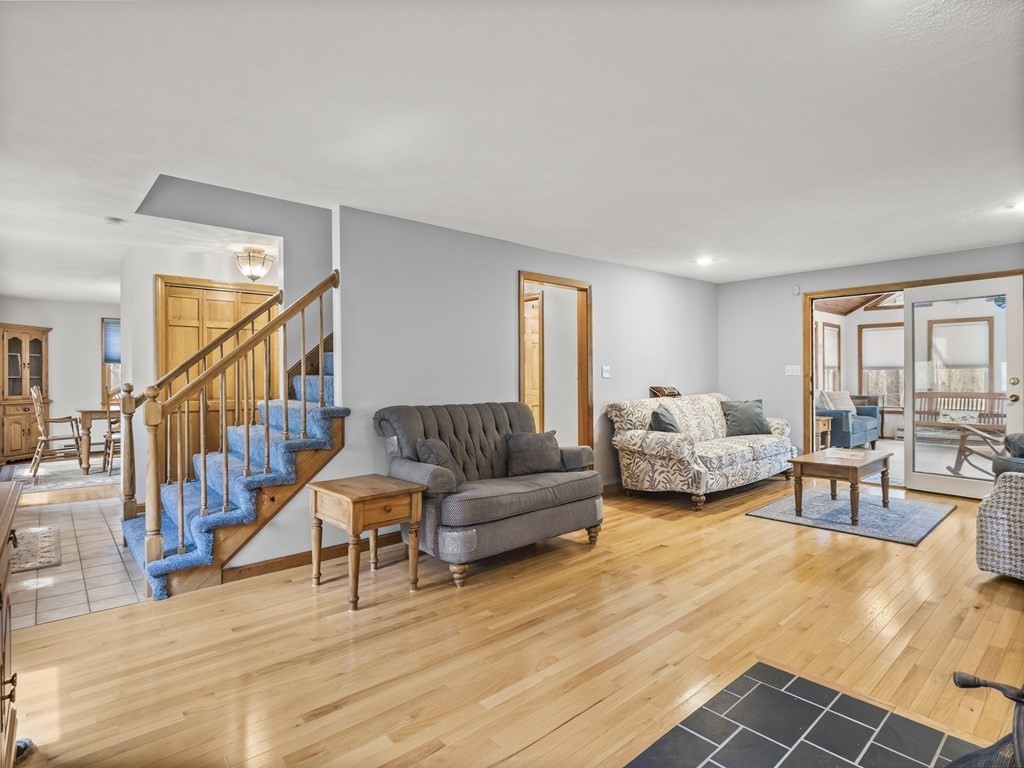 17 Chestnut Road Tyngsboro, MA 01879 - Photo 3 of 41 a living room with furniture and a dining table with wooden floor