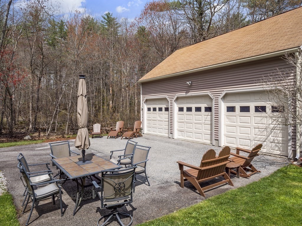17 Chestnut Road Tyngsboro, MA 01879 - Photo 32 of 41 a backyard of a house with table and chairs