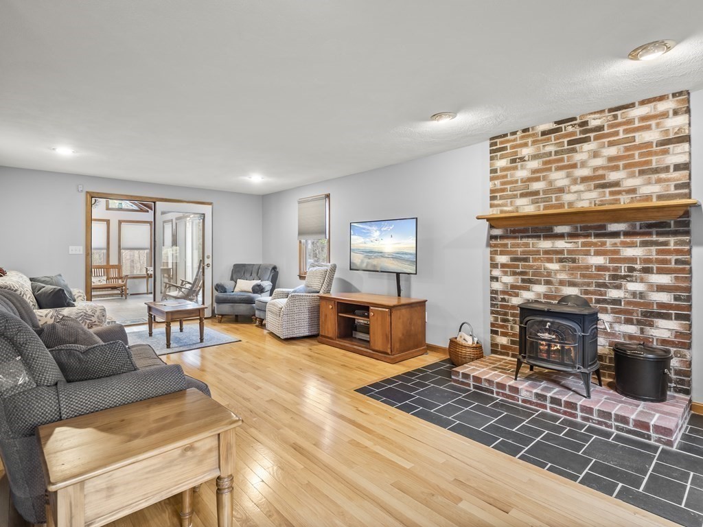 17 Chestnut Road Tyngsboro, MA 01879 - Photo 4 of 41 a living room with furniture and a fireplace