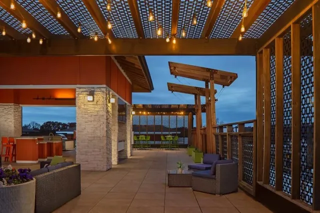 a view of a patio with a table and chairs