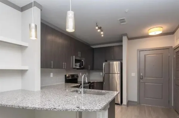 a kitchen with refrigerator and furniture