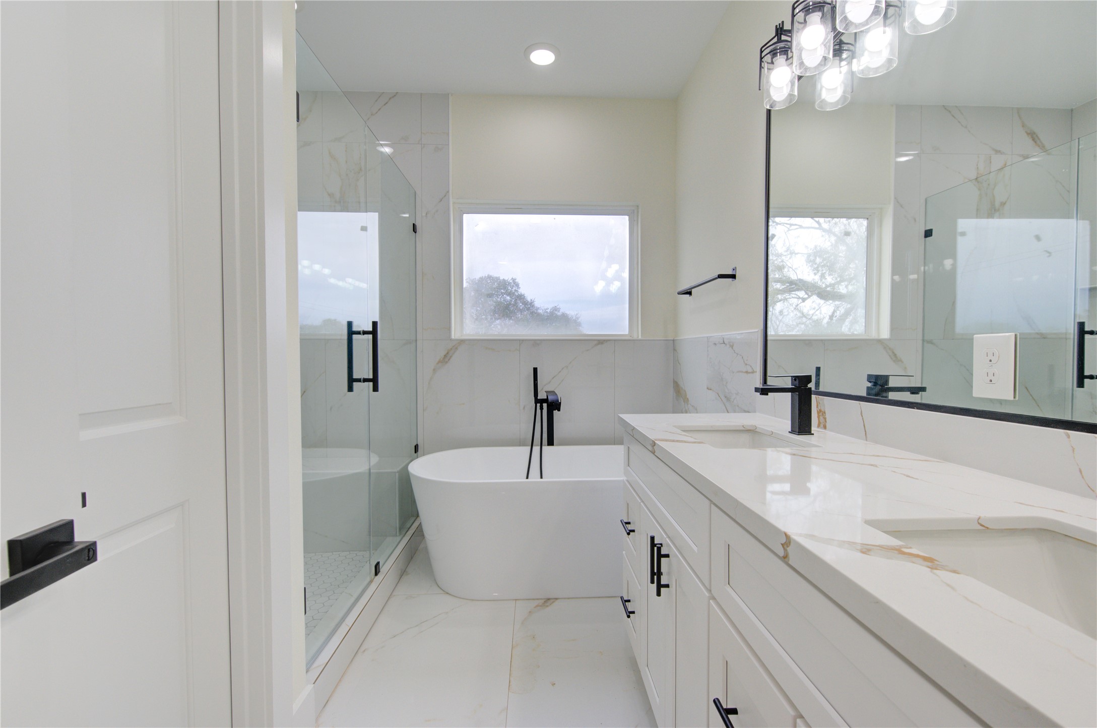4308 Alice Street Houston, TX 77021 - Photo 21 of 25 a bathroom with a double vanity sink a mirror and a bathtub