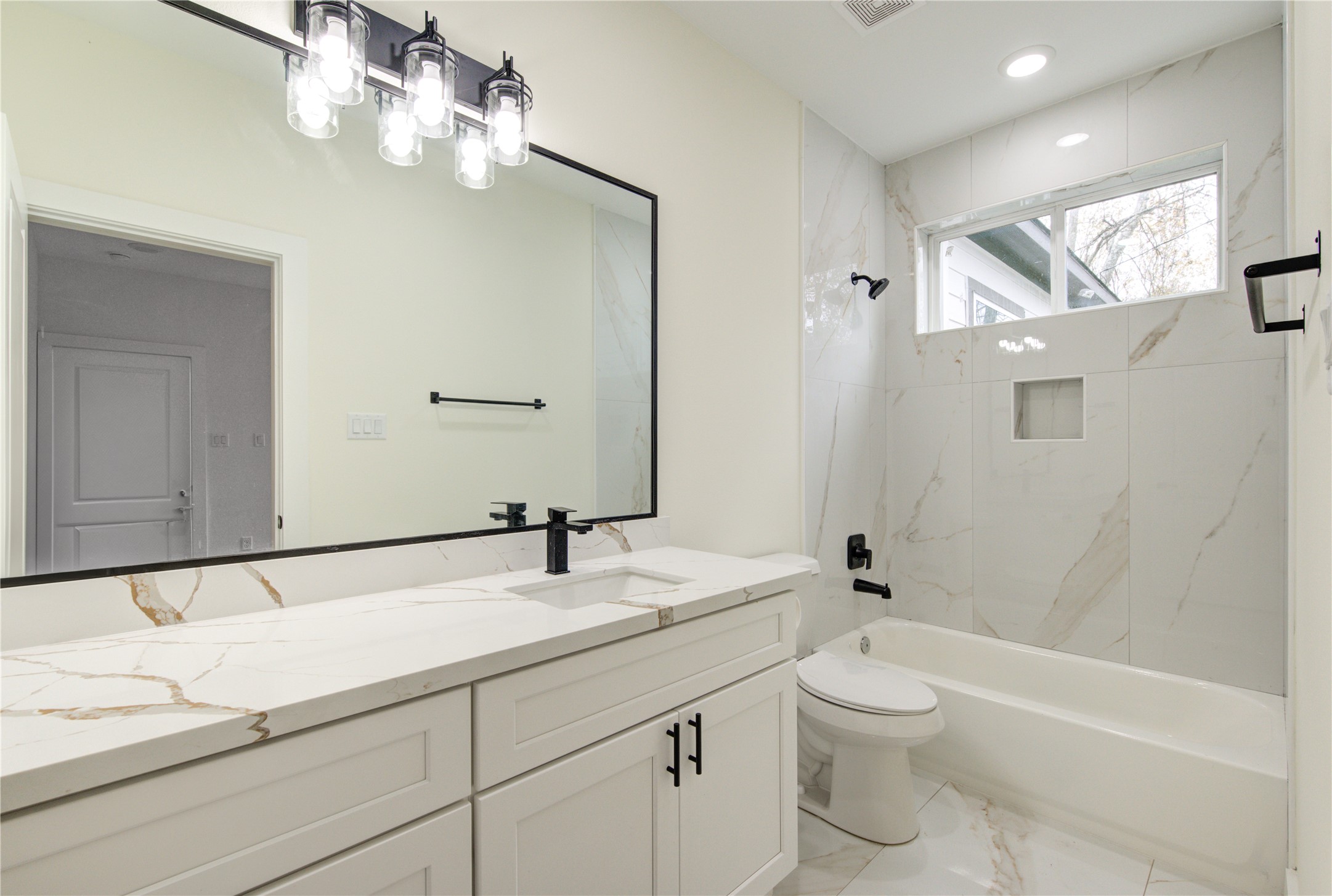 4308 Alice Street Houston, TX 77021 - Photo 5 of 25 a bathroom with a granite countertop sink a toilet and bathtub