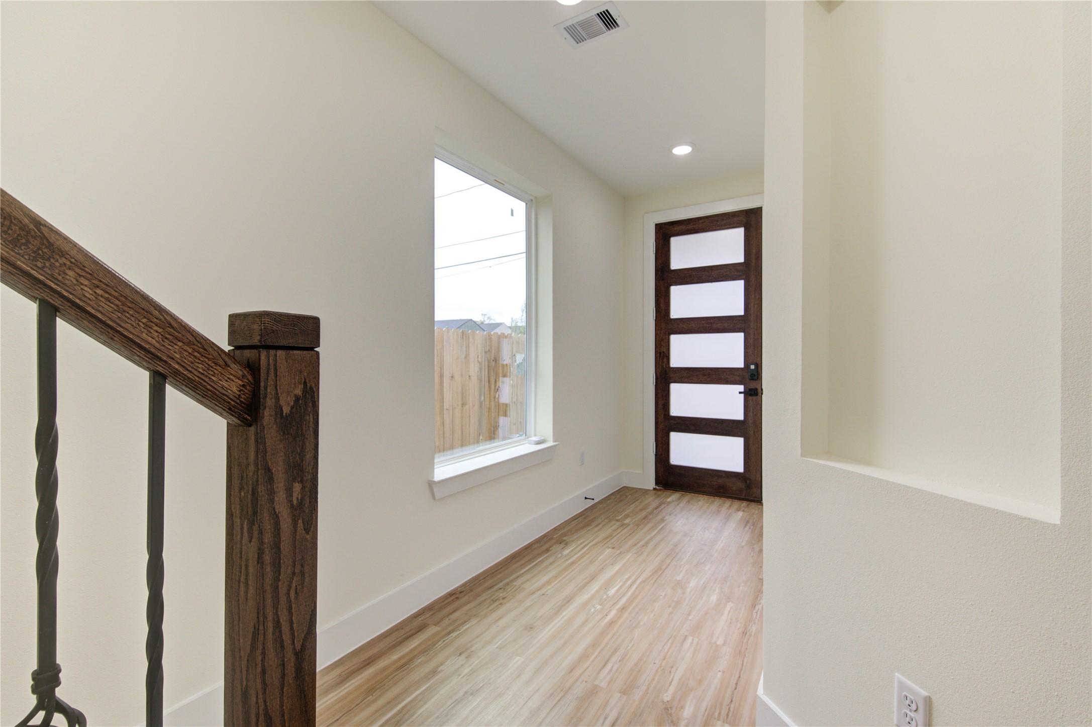 4308 Alice Street Houston, TX 77021 - Photo 8 of 25 an empty room with wooden floor and windows