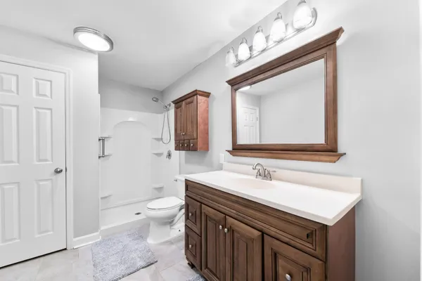 a bathroom with a sink vanity and a mirror