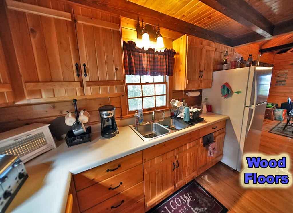 803 Chadwick Pt Road Weston, ME 04424 - Photo 19 of 116 kitchen-knotty-pine-cabinet