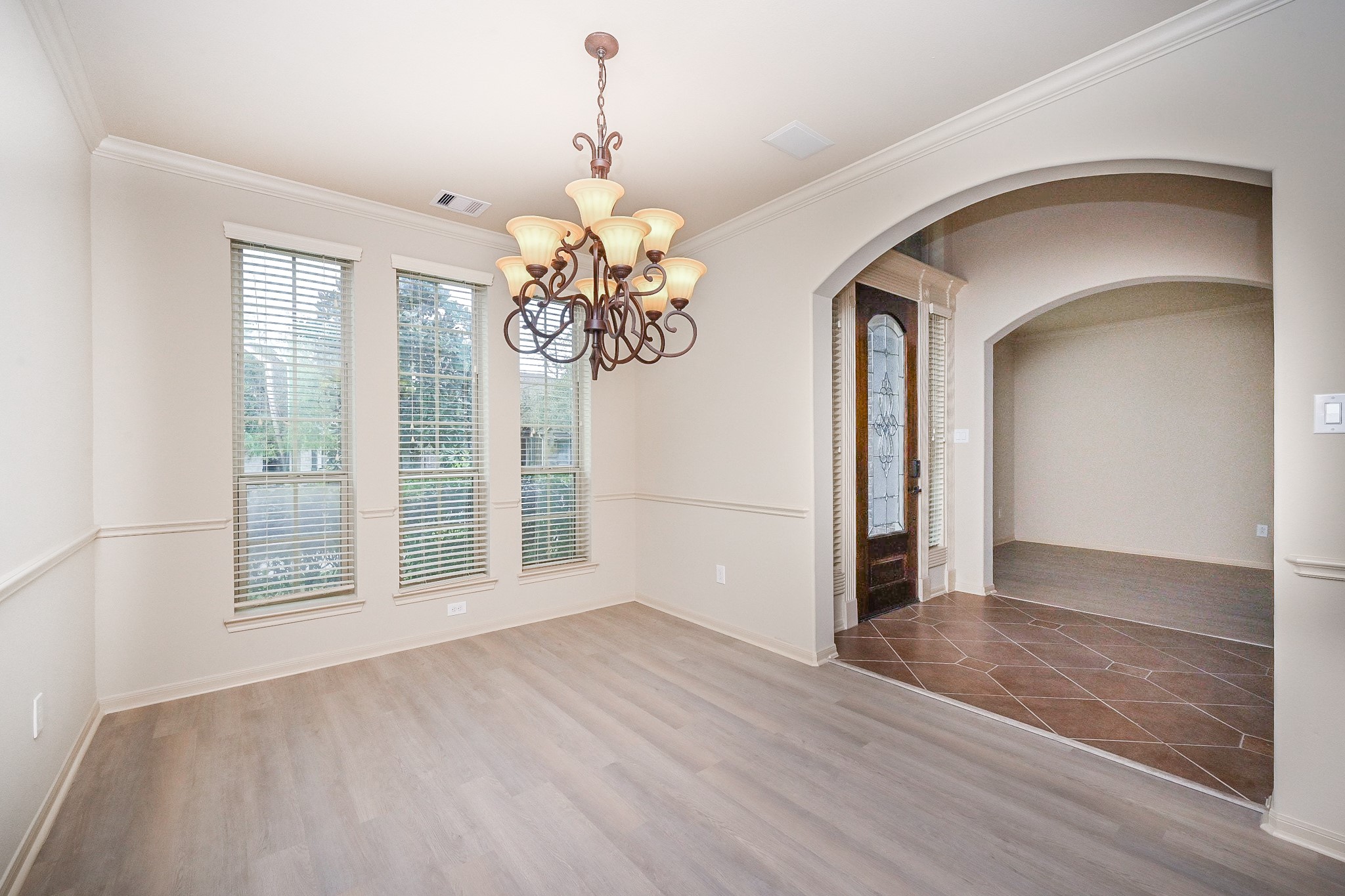 19 Sandwell Place Spring, TX 77389 - Photo 5 of 33 Formal dining room with abundant natural light and classic chandelier
