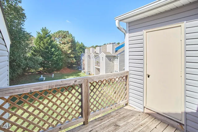 view of a hallway with wooden floor and closet area