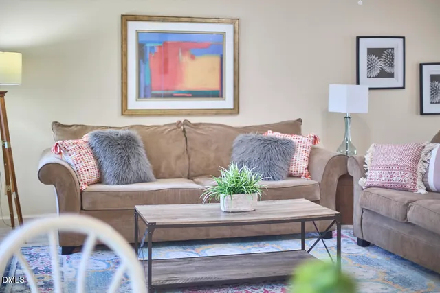 a living room with furniture and a potted plant