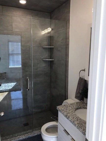 21 5th Street, Unit 20 Chelsea, MA 02150 - Photo 6 of 9 a bathroom with a granite countertop sink a toilet and shower