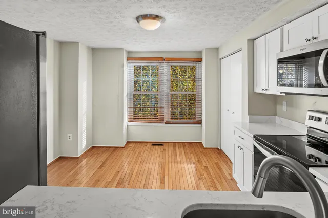 a living room with a bed furniture and a window