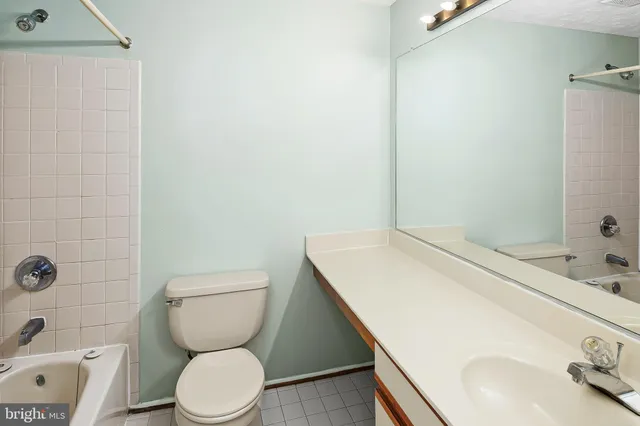 a bathroom with a toilet a sink and shower