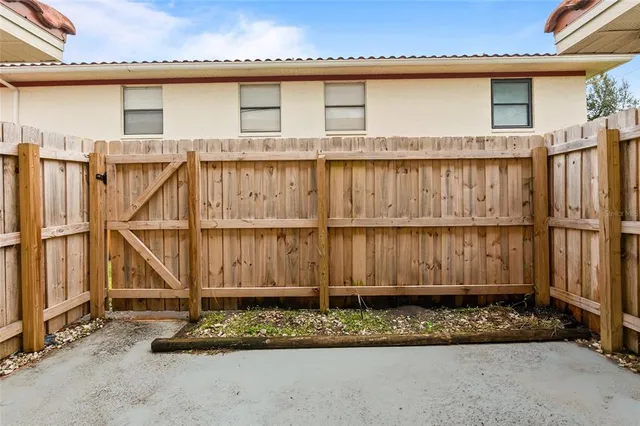 a view of a house with a wooden deck
