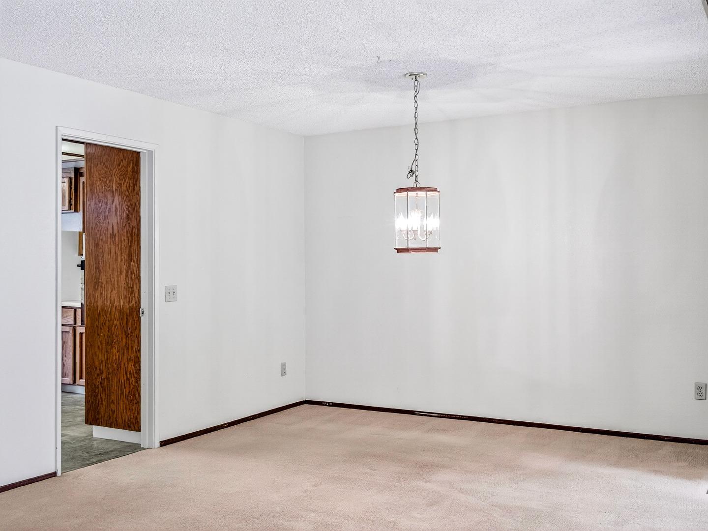 7391 Vía Cantares San Jose, CA 95135 - Photo 13 of 45 a view of a room with a hanging light and kitchen view