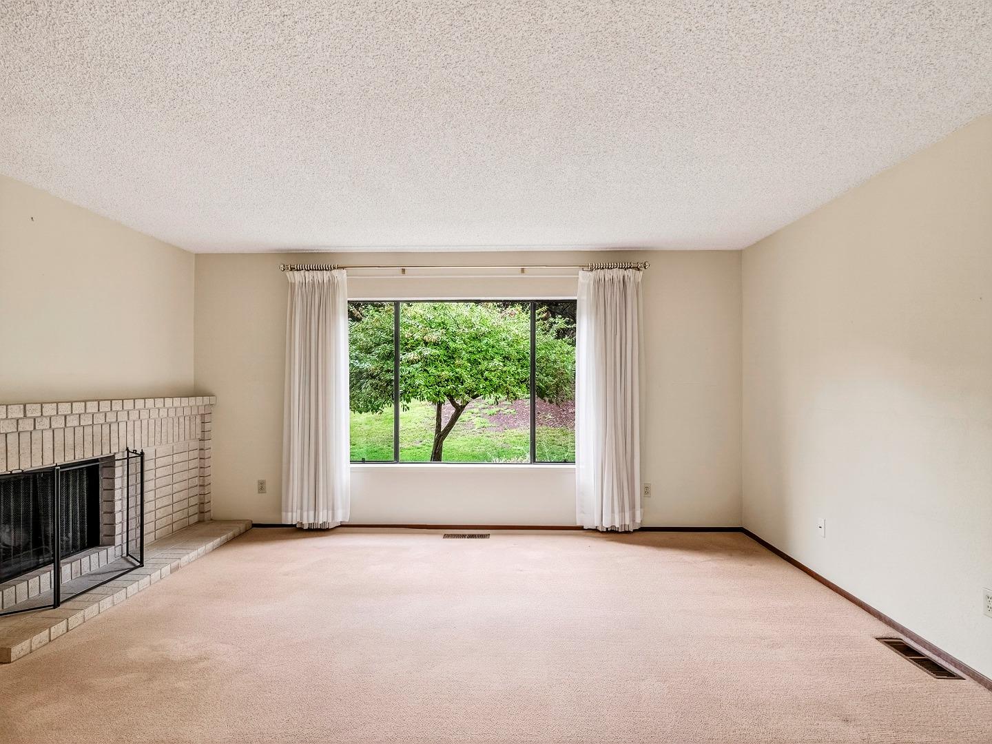 7391 Vía Cantares San Jose, CA 95135 - Photo 18 of 45 an empty room with windows and fireplace