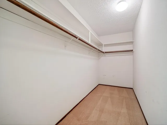 a bedroom with a bed a couch and a window