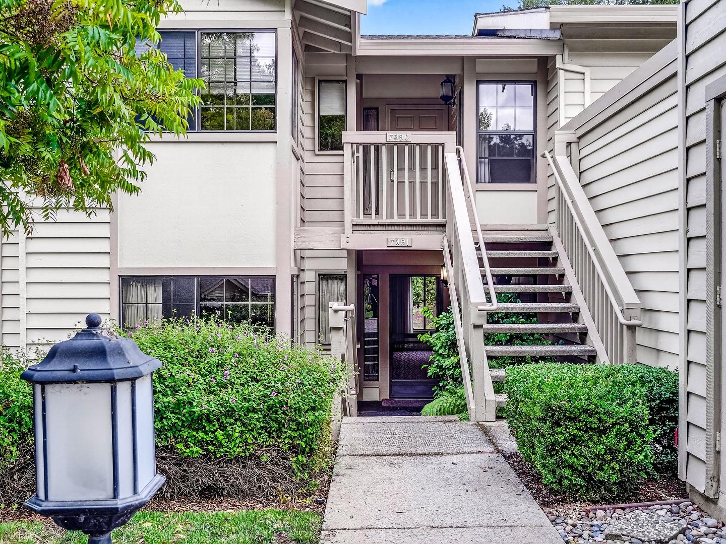 7391 Vía Cantares San Jose, CA 95135 - Photo 3 of 45 a view of a brick house with plants and large tree