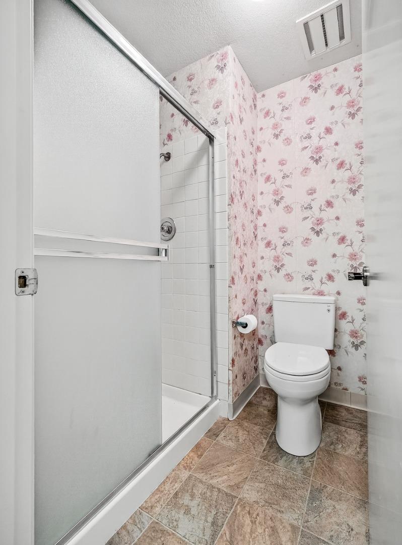 7391 Vía Cantares San Jose, CA 95135 - Photo 31 of 45 a bathroom with a toilet and a shower