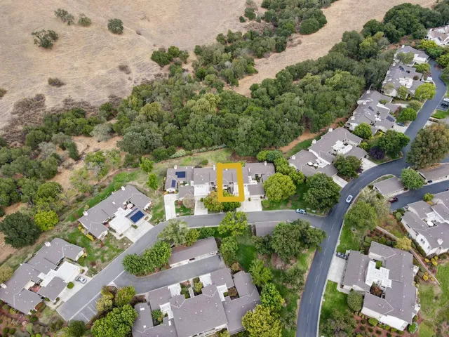 an aerial view of a house with swimming pool and garden