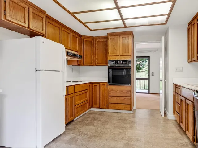 a kitchen with granite countertop a refrigerator and a stove
