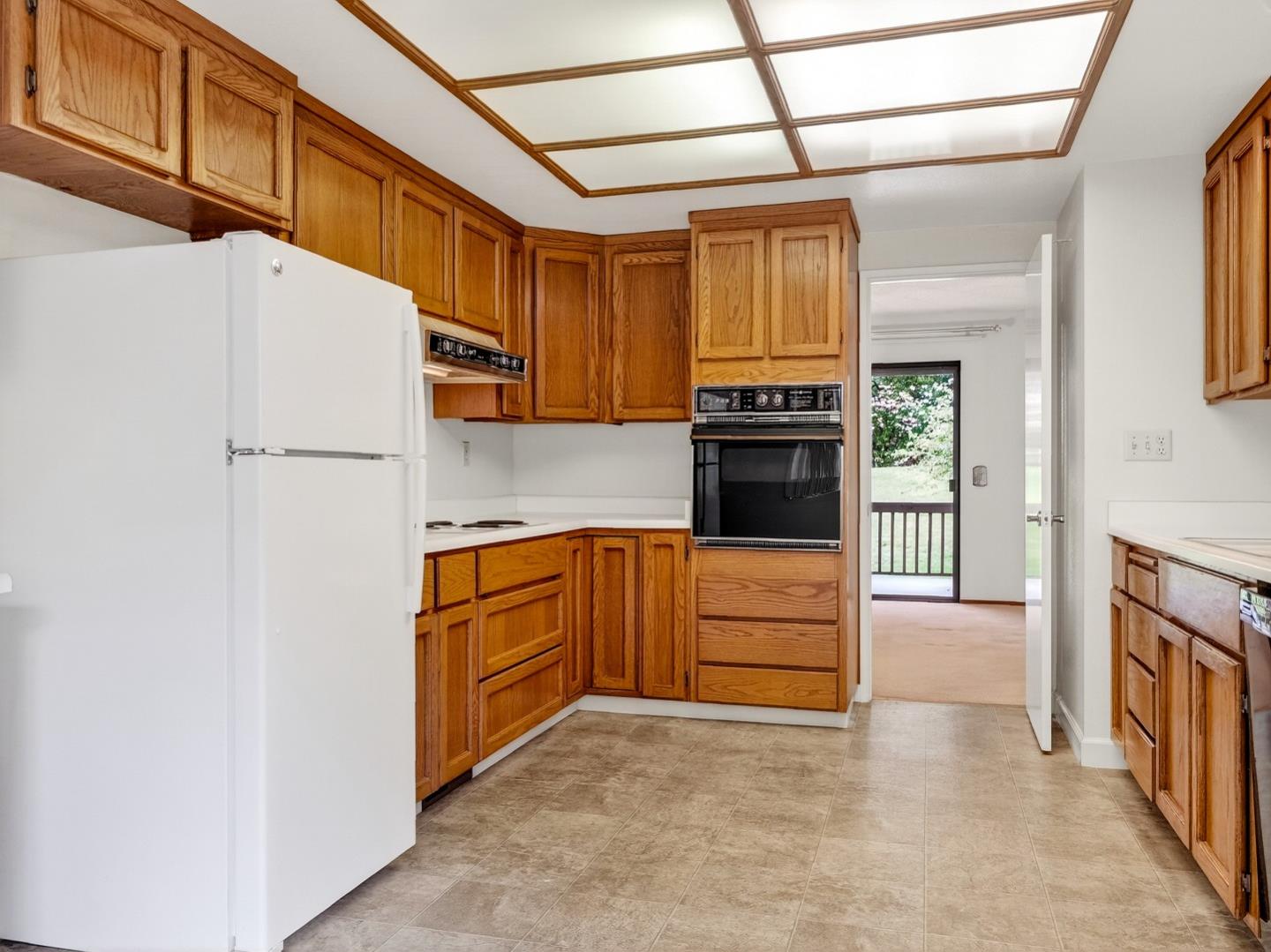 7391 Vía Cantares San Jose, CA 95135 - Photo 5 of 45 a kitchen with granite countertop a refrigerator and a stove