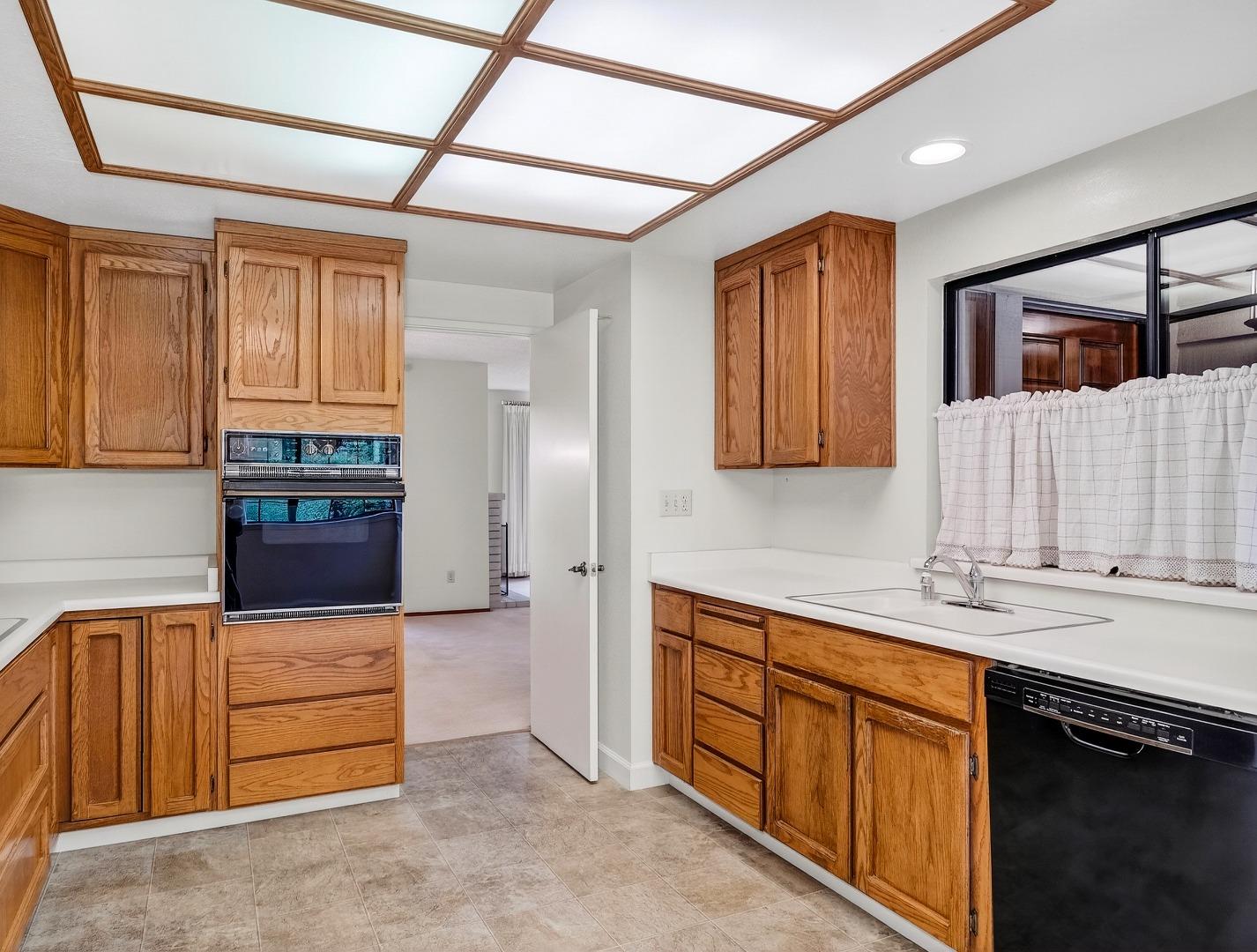 7391 Vía Cantares San Jose, CA 95135 - Photo 7 of 45 a kitchen with stainless steel appliances granite countertop a refrigerator and wooden cabinets