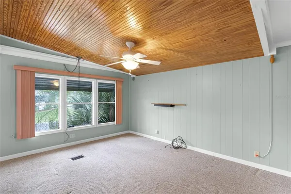 a view of a livingroom with a ceiling fan and window