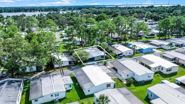 an aerial view of a house with a yard basket ball court and outdoor seating