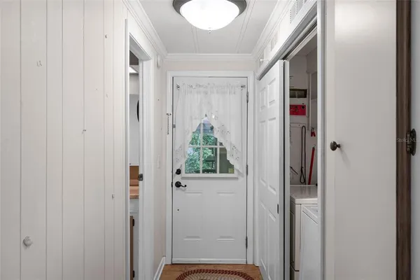a view of washer and dryer with bathroom in the background